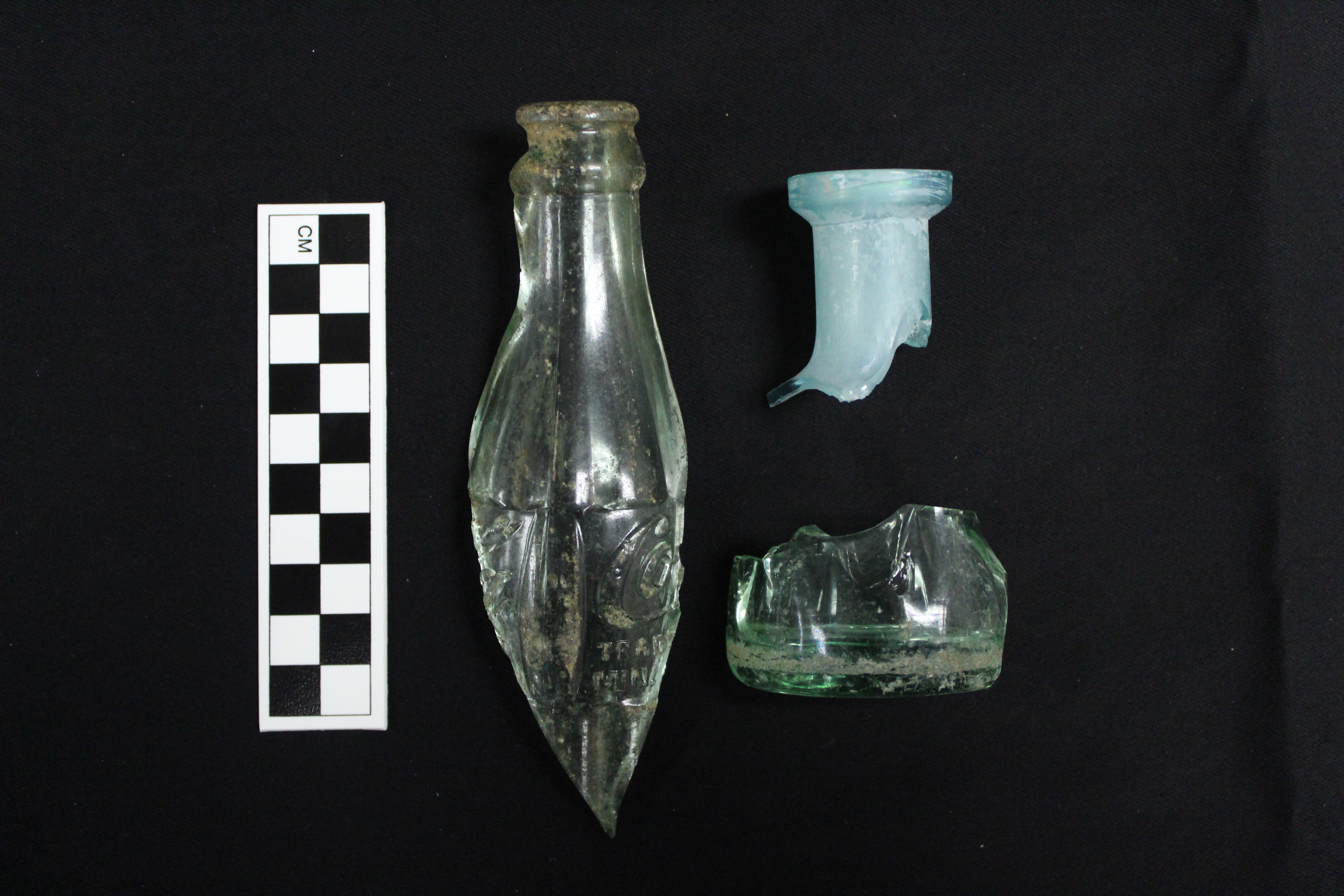 sections of three different historic glass bottles