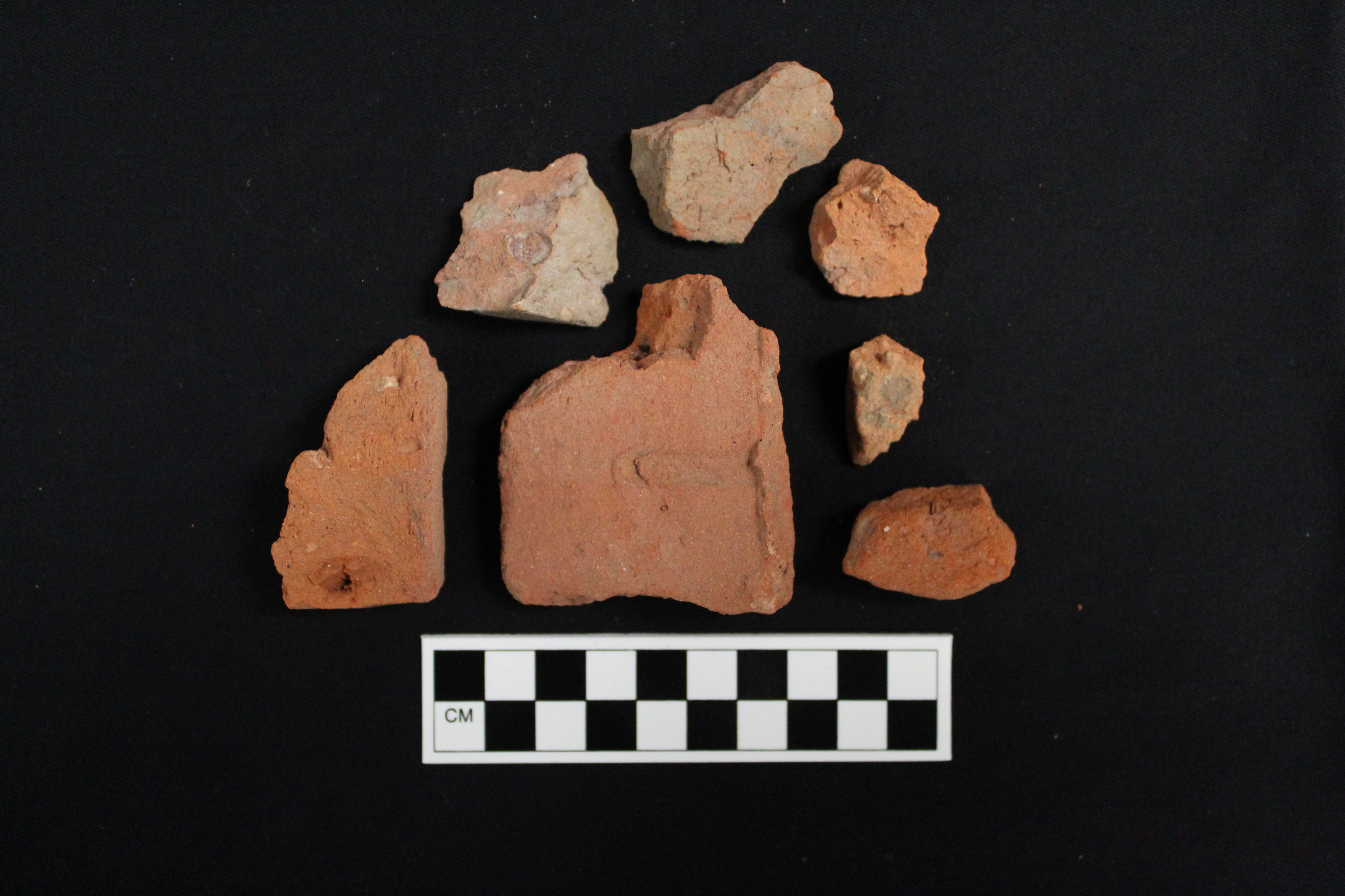 six red brick fragments of varying sizes
