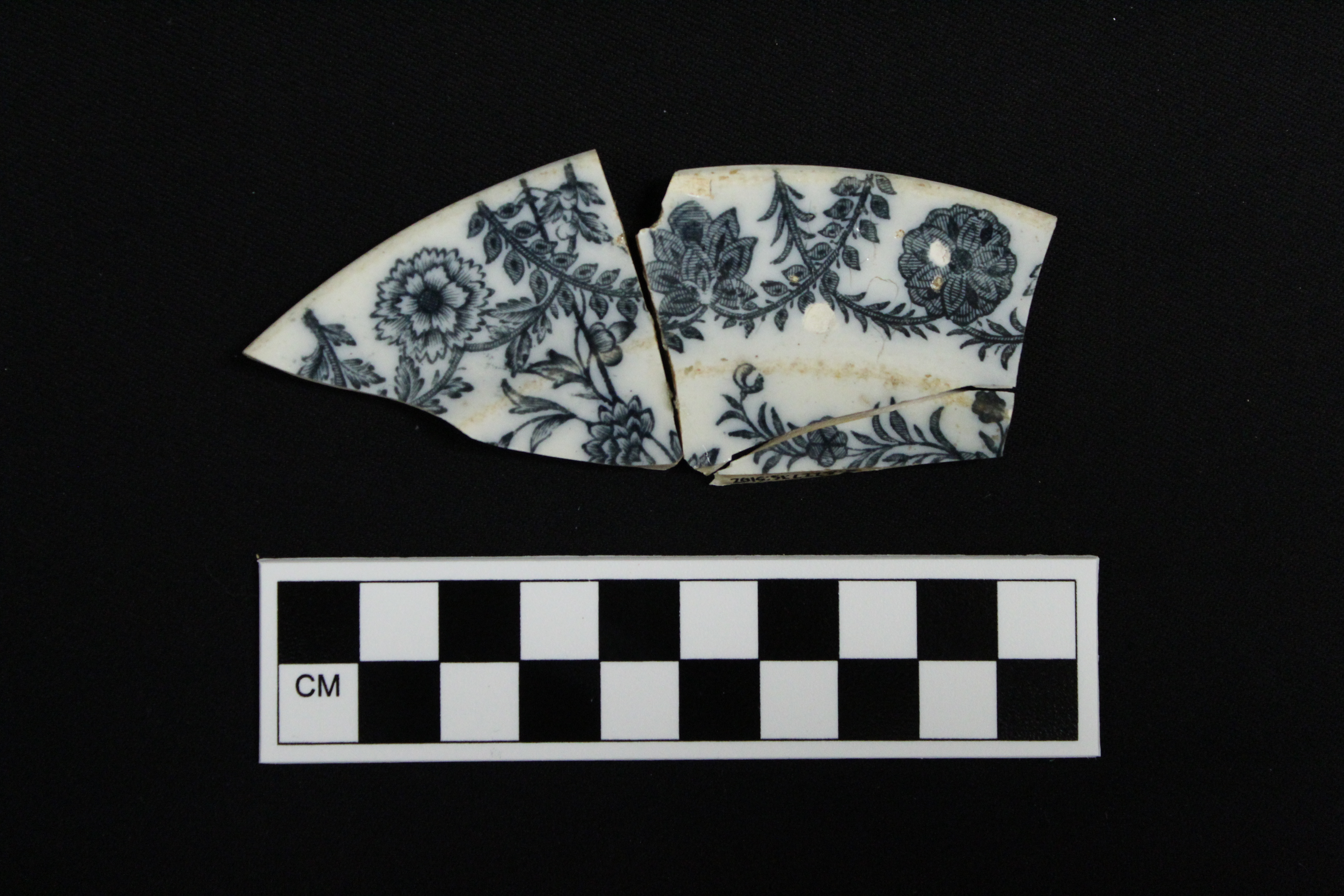 one section of broken white tea saucer, white with grey floral designs