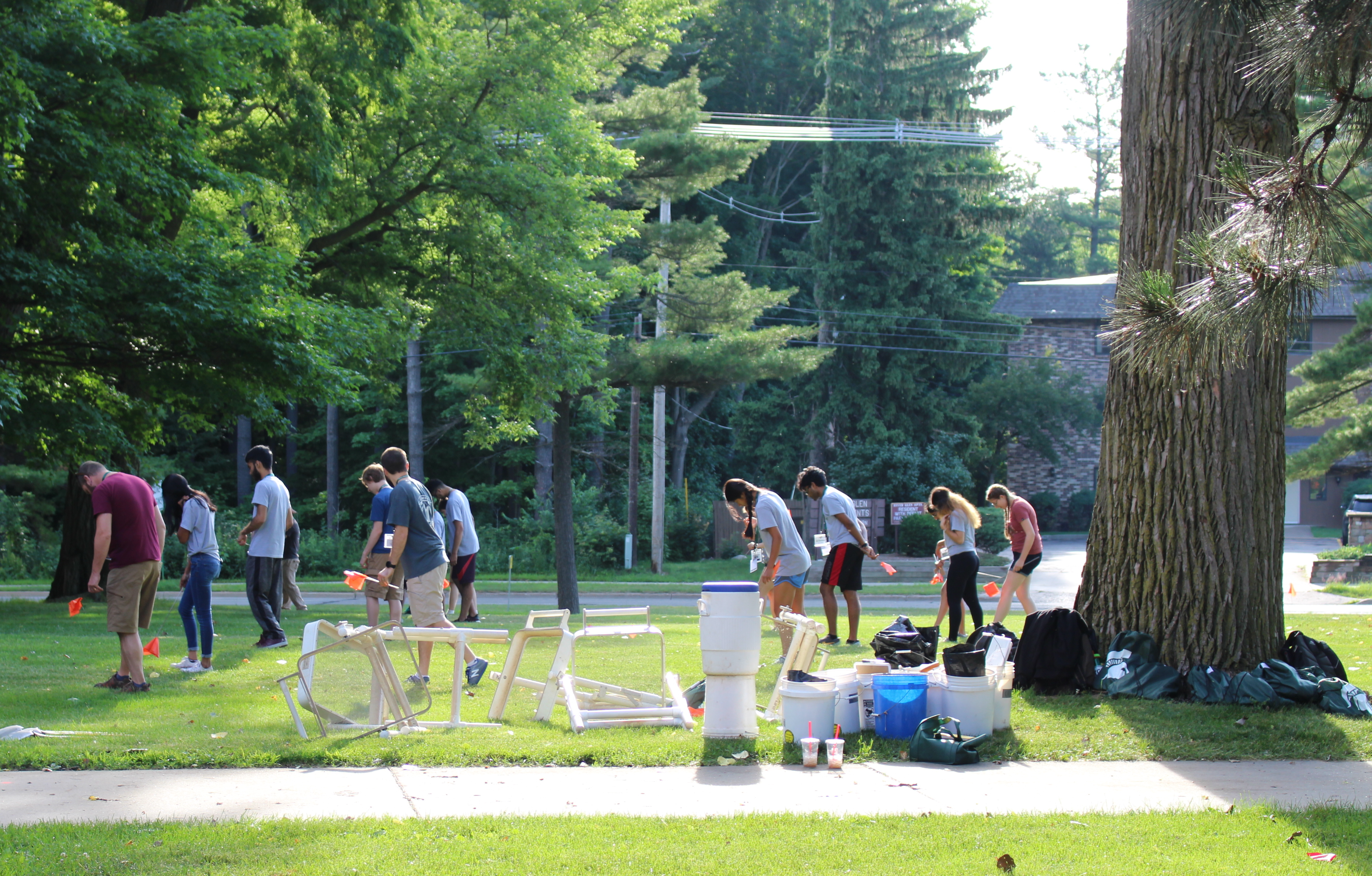Eleven undergraduates walking a mowed field to find artifacts